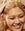 Woman washing her hair with Acure shampoo